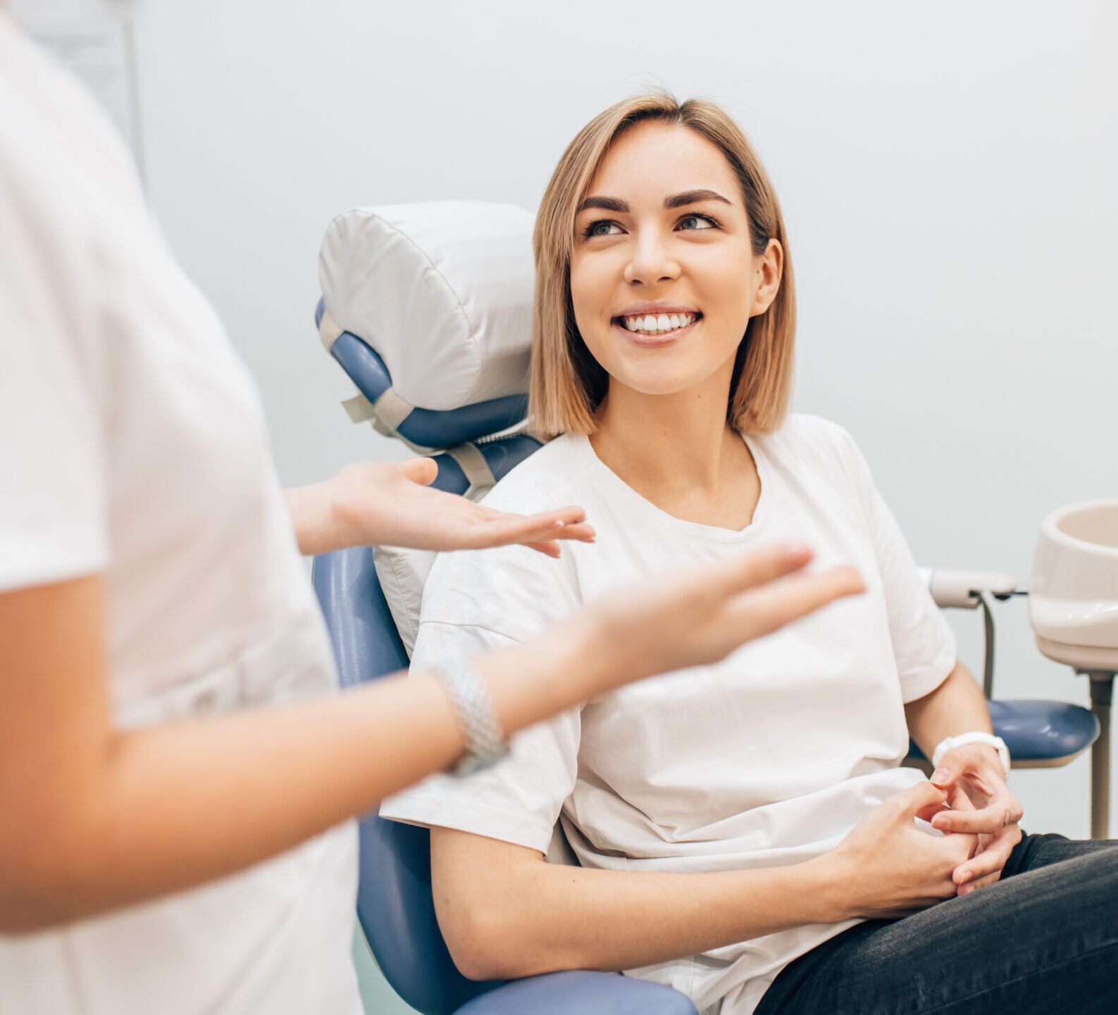 young beautiful lady with blond short hair sit in dentist office, waiting for a teeth treatment. Medicine, dentist concept