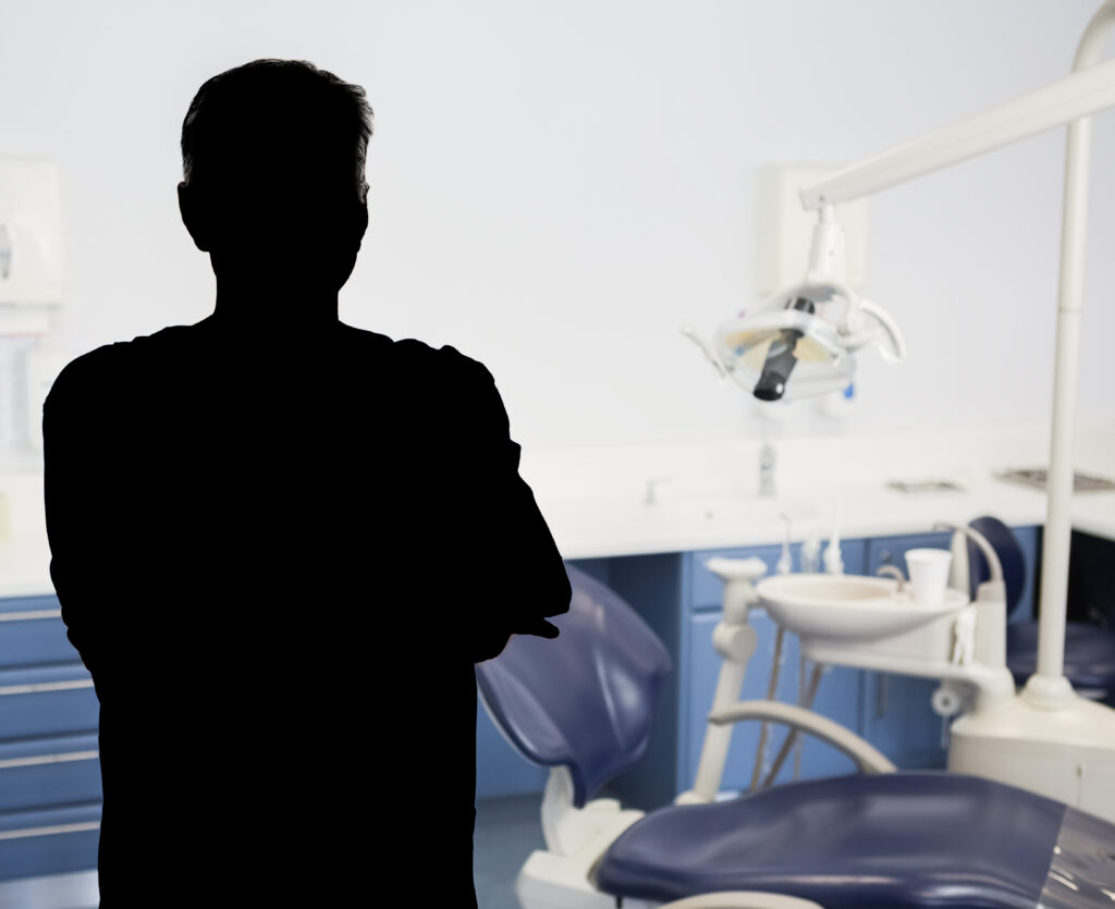 Portrait of a friendly dentist with arms crossed