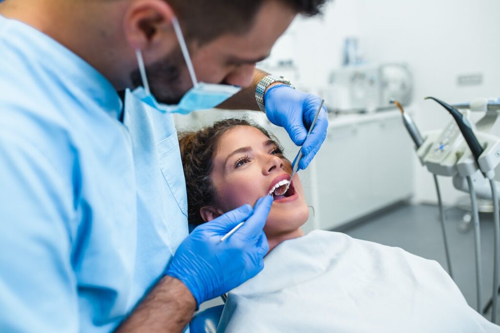 Woman receiving a dental crown evaluation at the dentist's office